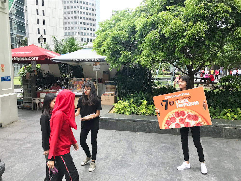 Caesar walkway flyer distribution raffles place with distributors holding ad board and distributing flyers 3