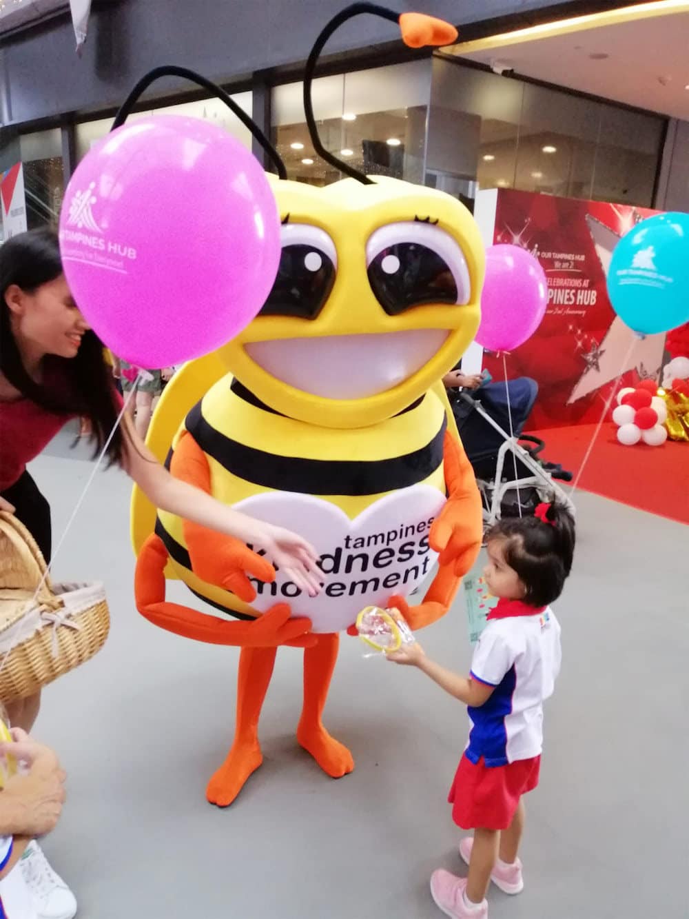 Walkway flyer distribution tampines hub bee mascot with child