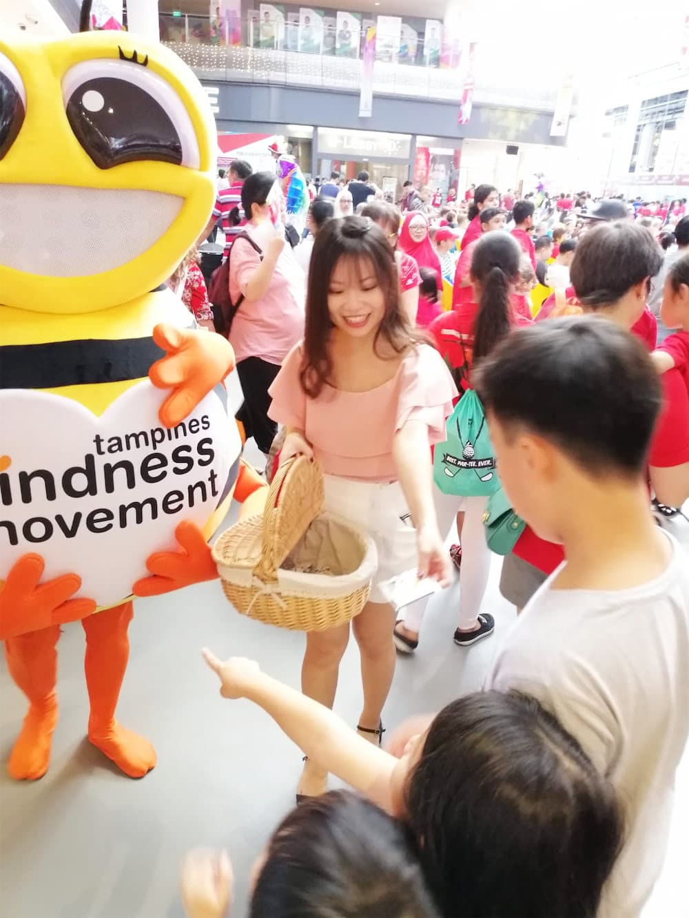 Walkway flyer distribution tampines hub bee mascot with distributor and crowd 2