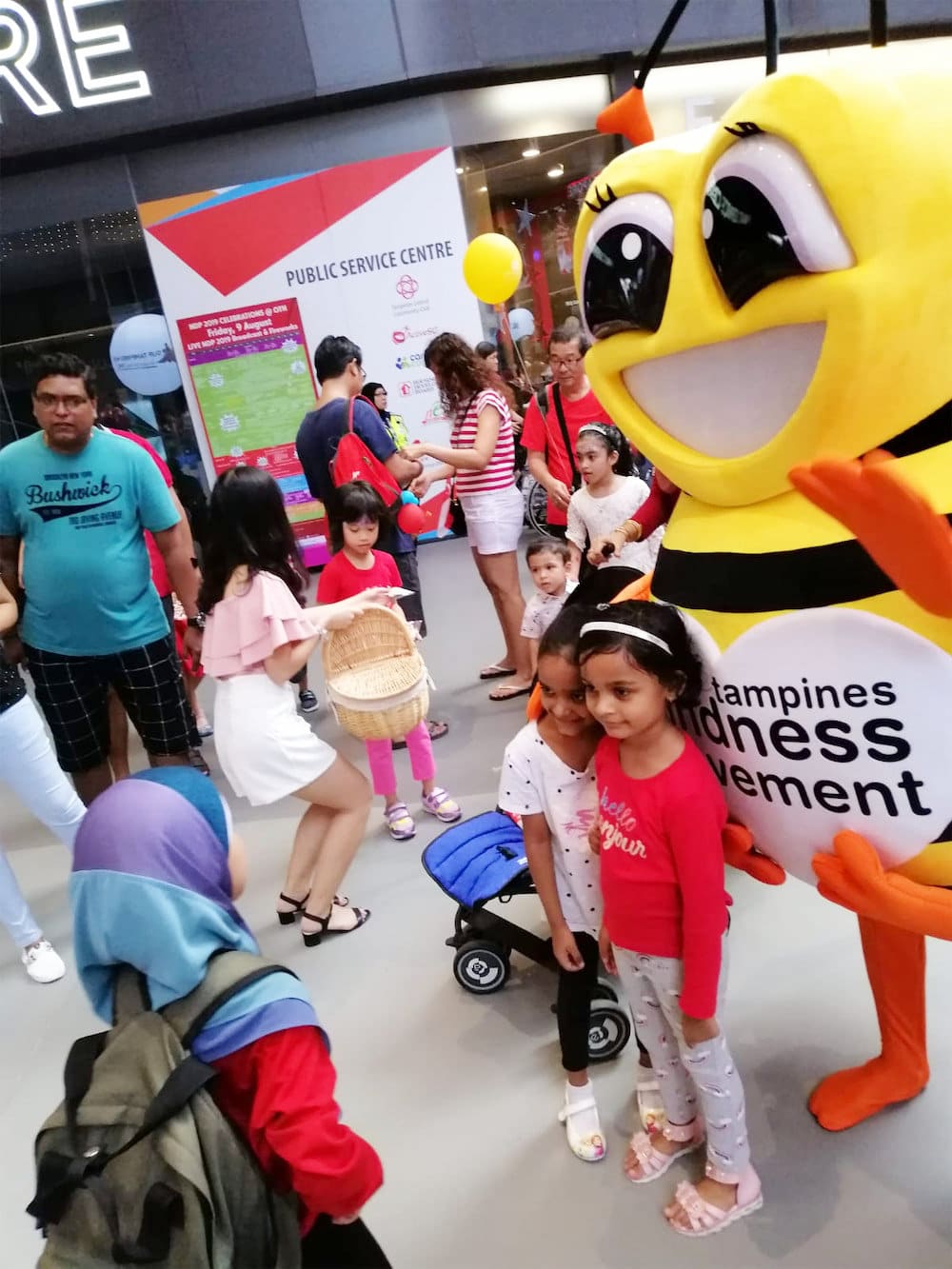 Walkway flyer distribution tampines hub bee mascot with distributor and crowd 3