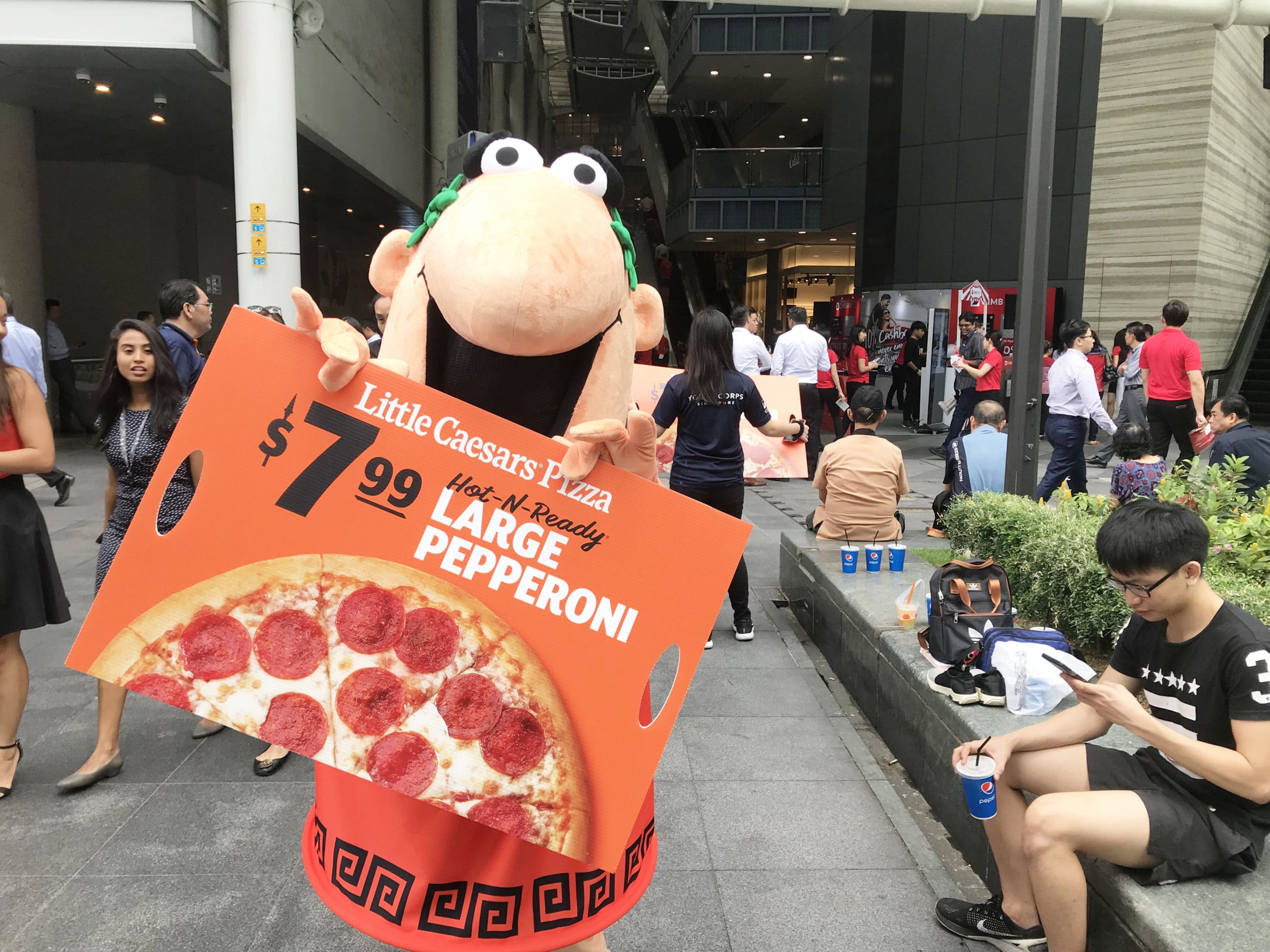 caesar walkway flyer distribution raffles place with mascot holding ad board scaled