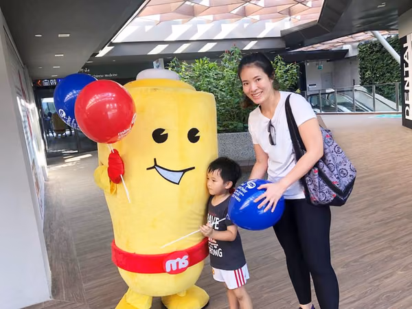 Events Marketing Walkway Flyer Distribution Mindstretcher mascot with child mother