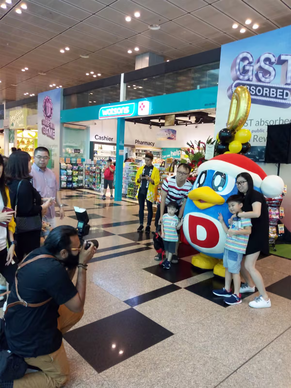 don don donki at changi jewel event marketing with mascot posing for photo with people 10