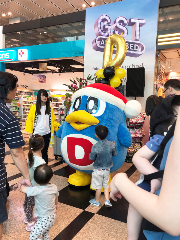 don don donki at changi jewel event marketing with mascot posing for photo with people 11