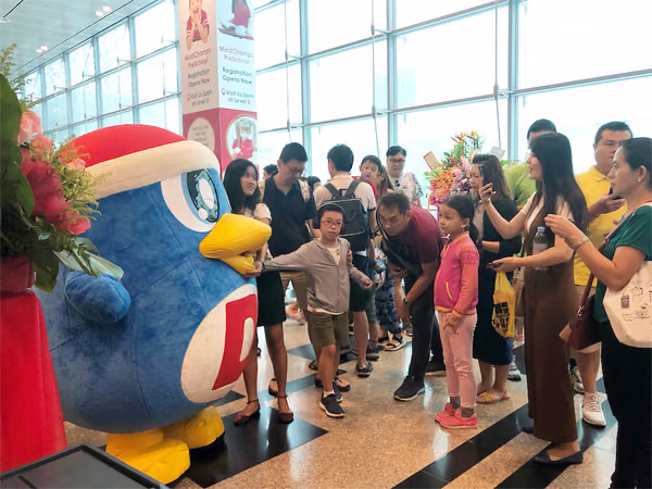 don don donki at changi jewel event marketing with mascot posing for photo with people 2