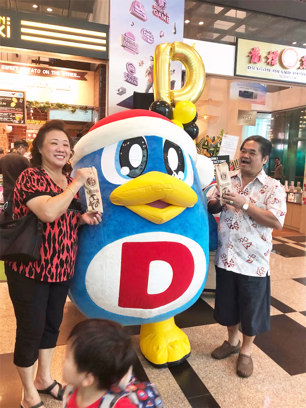 don don donki at changi jewel event marketing with mascot posing for photo with people 3