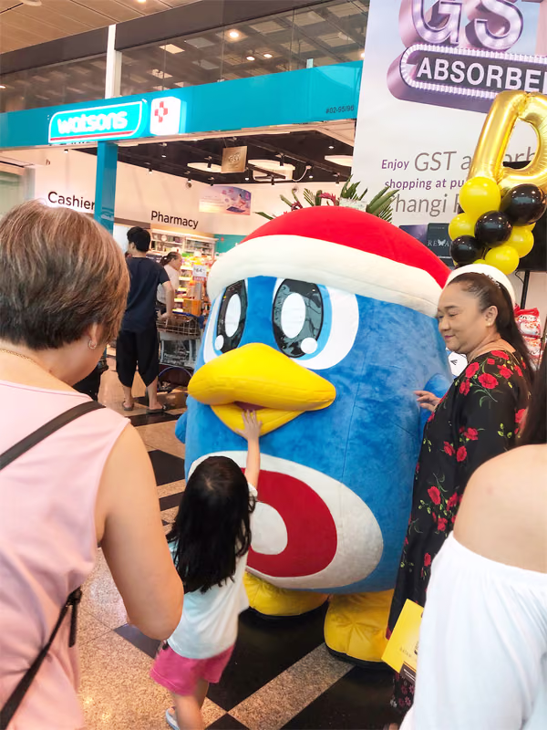 don don donki at changi jewel event marketing with mascot posing for photo with people 5