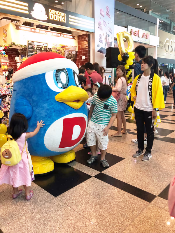 don don donki at changi jewel event marketing with mascot posing for photo with people 6