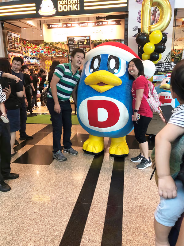 don don donki at changi jewel event marketing with mascot posing for photo with people 7
