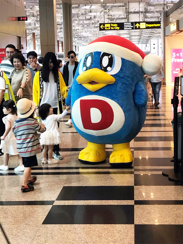 don don donki at changi jewel event marketing with mascot posing for photo with people 8