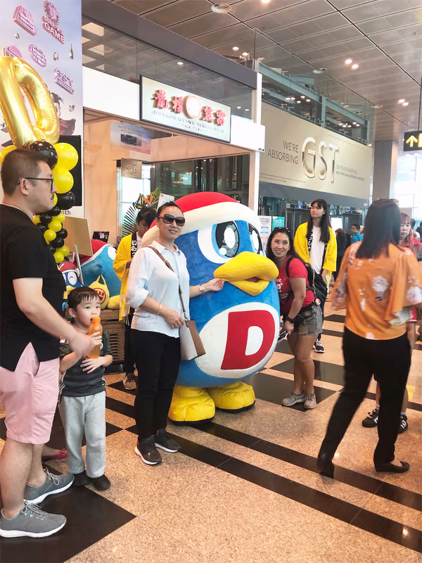 don don donki at changi jewel event marketing with mascot posing for photo with people 9