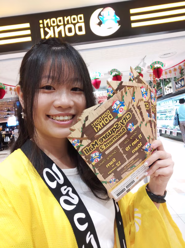 don don donki at city square event marketing with staff holding flyer for distribution