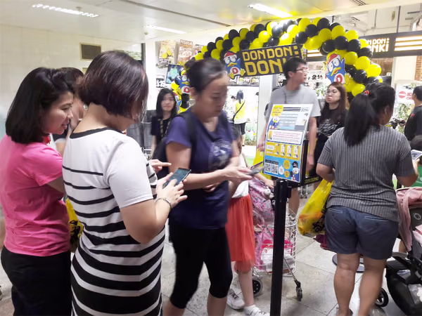 don don donki at novena event handing out sweet potatos